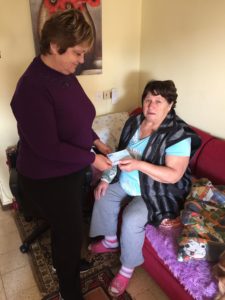 Leah giving check Raphael Billadarsky  (waited 8 months & had heart attack- no coverage, 80,000 shek bill)